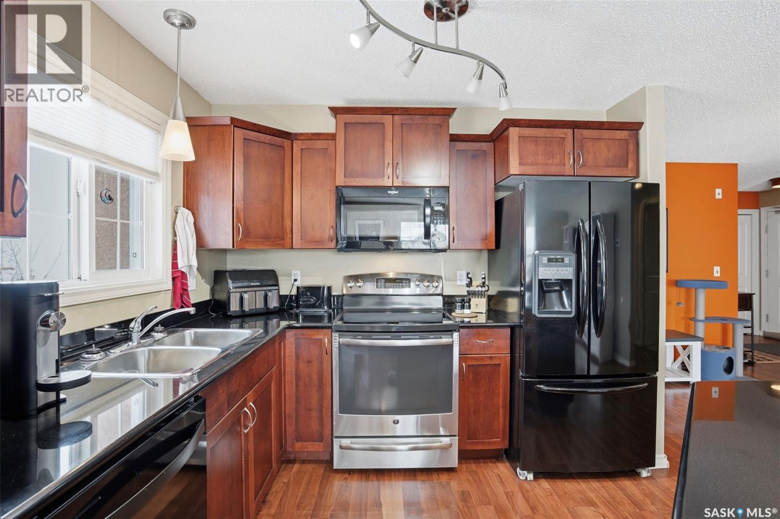 A206 103 Wellman Crescent, Saskatoon, SK - Indoor Photo Showing Kitchen With Double Sink