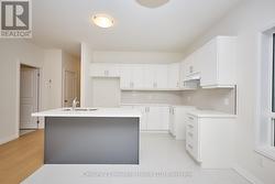 Kitchen with island and bright dining area -