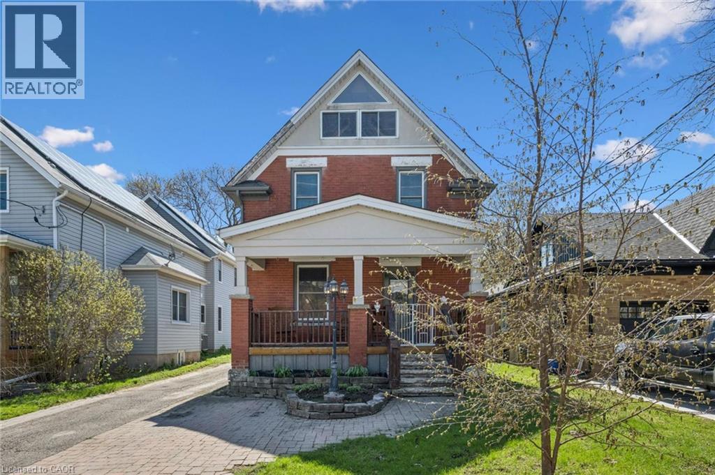 Brick exterior with a prominent front porch, white columns, and a pediment-style roofline - 115 Allen Street E, Waterloo, ON - Outdoor With Deck Patio Veranda