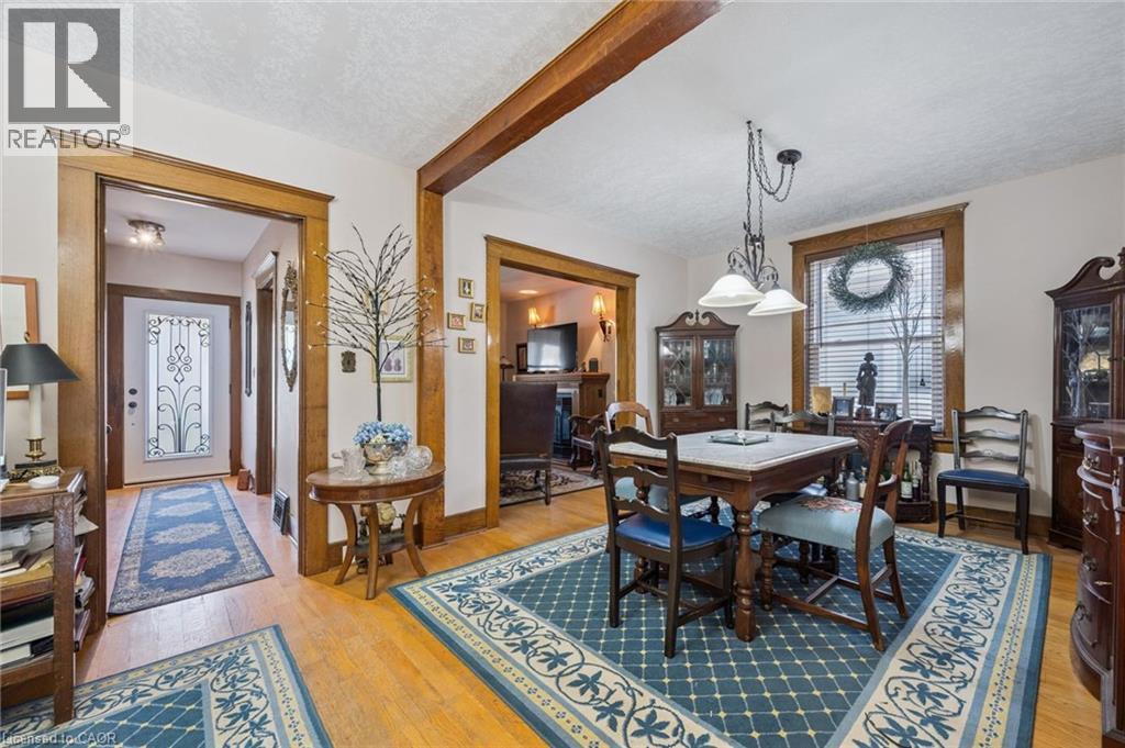 Hardwood flooring throughout the main living areas, featuring wide wooden trim and casings - 115 Allen Street E, Waterloo, ON - Indoor Photo Showing Dining Room