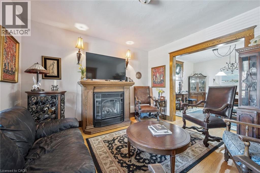 Living room featuring a wood-finish fireplace mantel and a decorative fireplace insert - 115 Allen Street E, Waterloo, ON - Indoor Photo Showing Living Room With Fireplace
