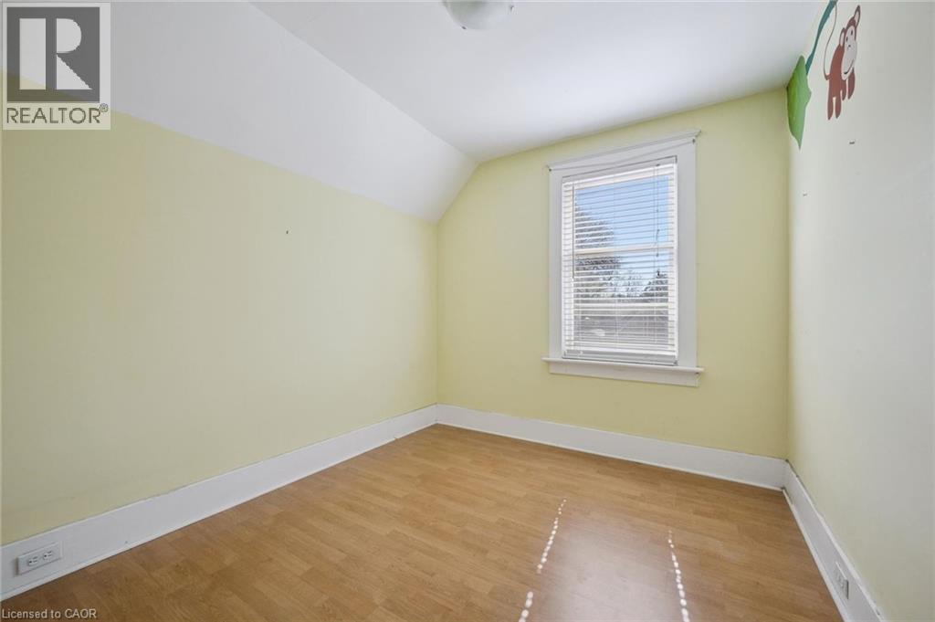 Room featuring wood-finish flooring, a single window with blinds, and light-colored walls - 115 Allen Street E, Waterloo, ON - Indoor Photo Showing Other Room