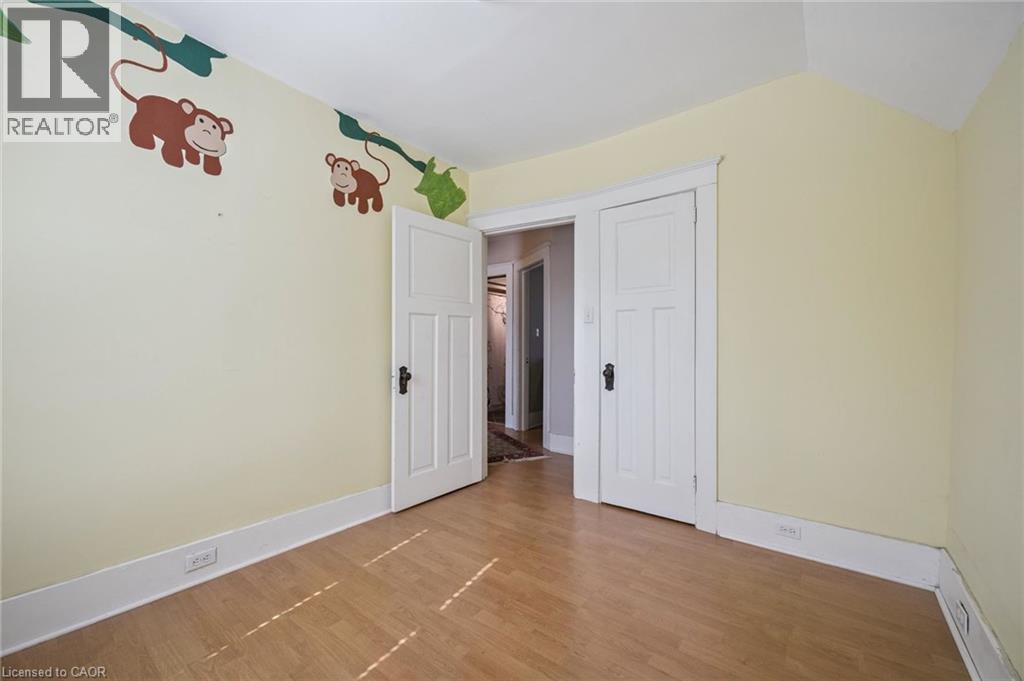 Light-toned wood-finish flooring with a subtle herringbone pattern - 115 Allen Street E, Waterloo, ON - Indoor Photo Showing Other Room