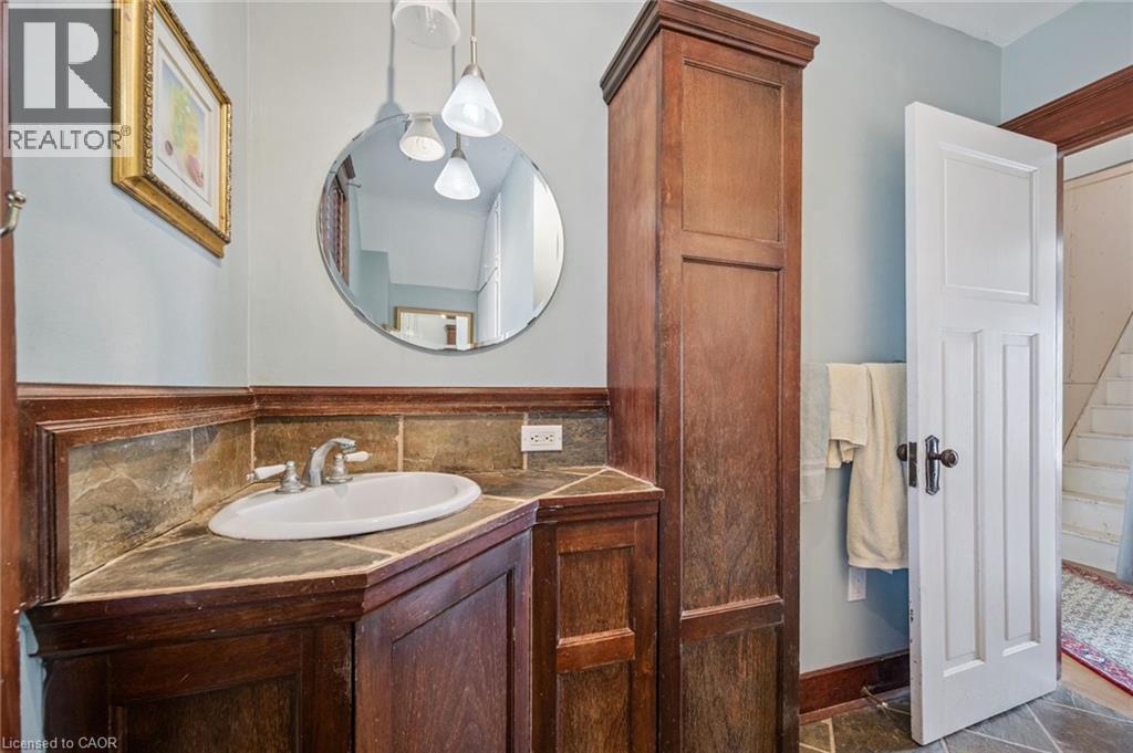 Corner vanity featuring a white oval sink and silver-finish faucet - 115 Allen Street E, Waterloo, ON - Indoor Photo Showing Bathroom