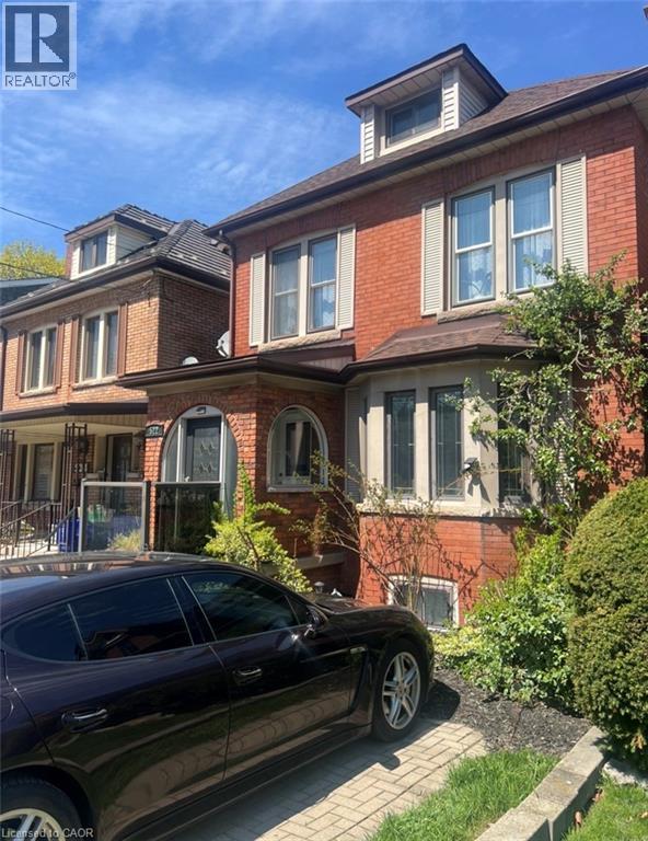 Brick facade residence featuring a prominent bay window, dormer window, and white louvered shutters - 522 Aberdeen Avenue, Hamilton, ON - Outdoor