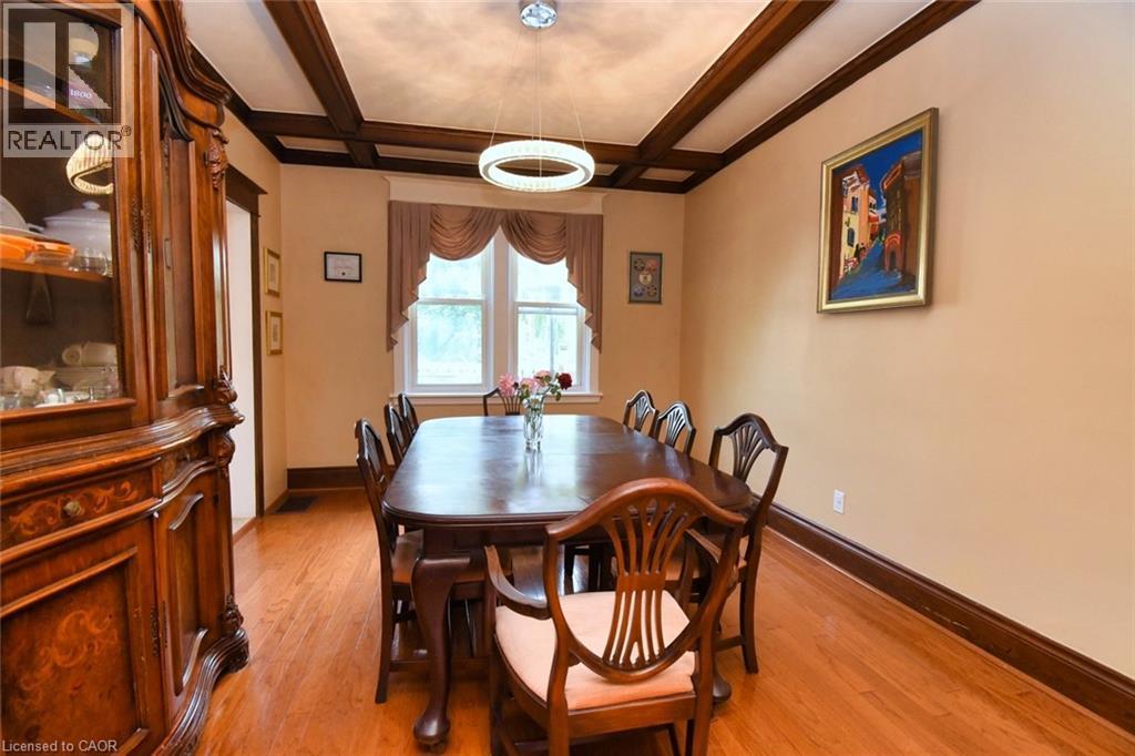 Hardwood flooring accents the room, complemented by detailed wood trim and a coffered ceiling - 522 Aberdeen Avenue, Hamilton, ON - Indoor Photo Showing Dining Room