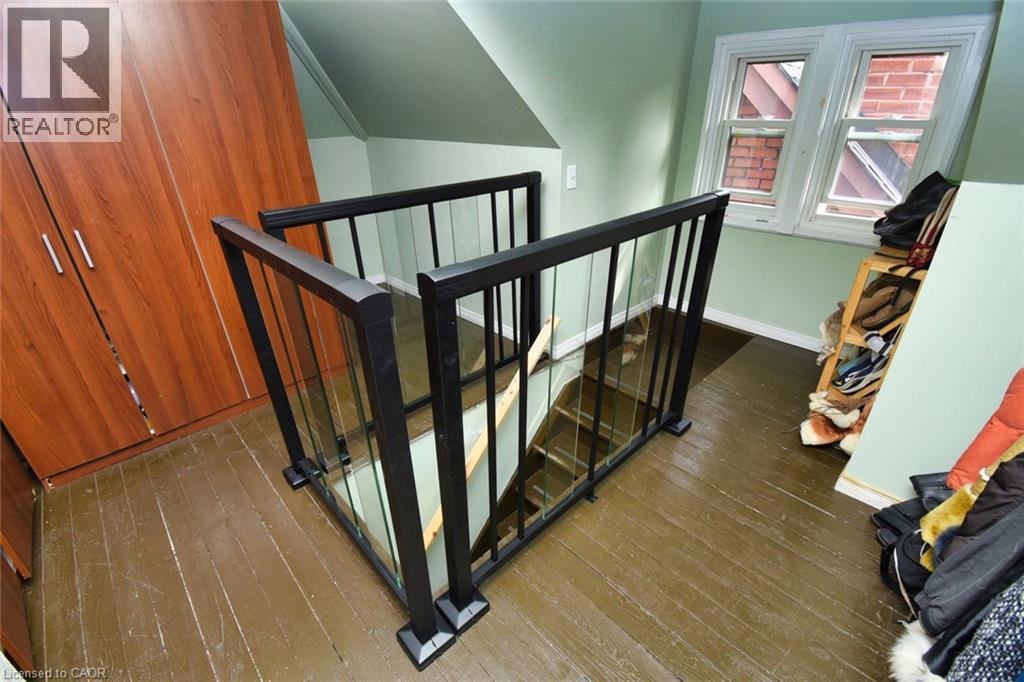 Stairwell with modern black railing and clear panels - 522 Aberdeen Avenue, Hamilton, ON - Indoor Photo Showing Other Room