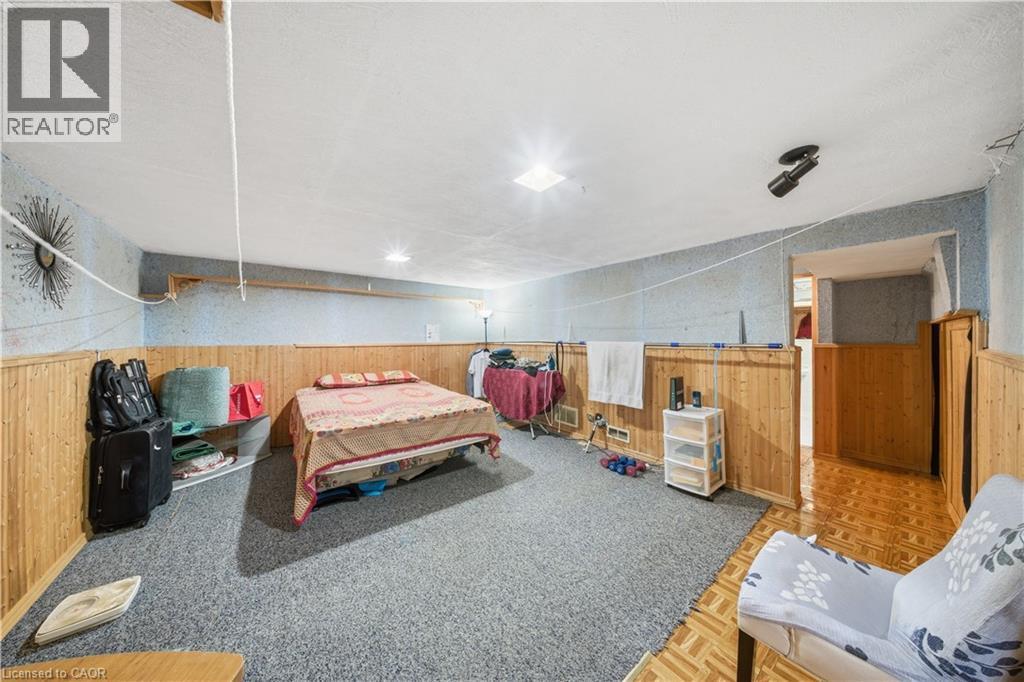Spacious room featuring wood-finish paneling, textured wall covering, and recessed lighting - 116 Gainsborough Road, Hamilton, ON - Indoor