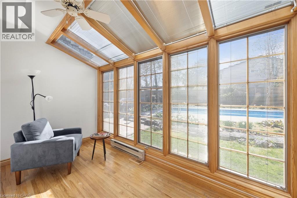 Sunroom featuring wood-finish flooring, a vaulted ceiling with exposed wood beams, and a ceiling fan - 277 Blackacres Boulevard, London, ON - Indoor Photo Showing Other Room