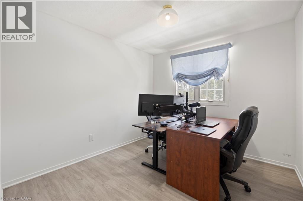 Room featuring light wood-finish flooring, white walls, and a single pane window with a light blue Roman shade - 277 Blackacres Boulevard, London, ON - Indoor Photo Showing Office