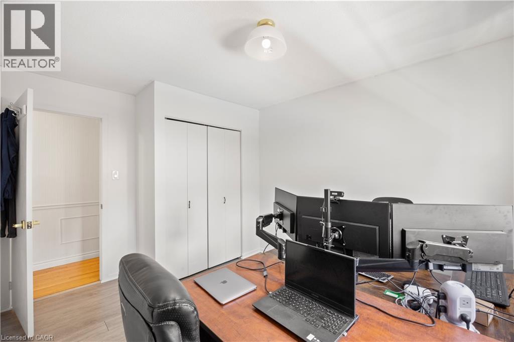Neutral wall finishes, a brass-tone flush mount light fixture, and a built-in closet with white bifold doors - 277 Blackacres Boulevard, London, ON - Indoor Photo Showing Other Room