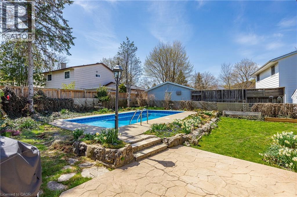Backyard featuring an in-ground swimming pool with concrete surround and metal handrails - 277 Blackacres Boulevard, London, ON - Outdoor With In Ground Pool With Backyard