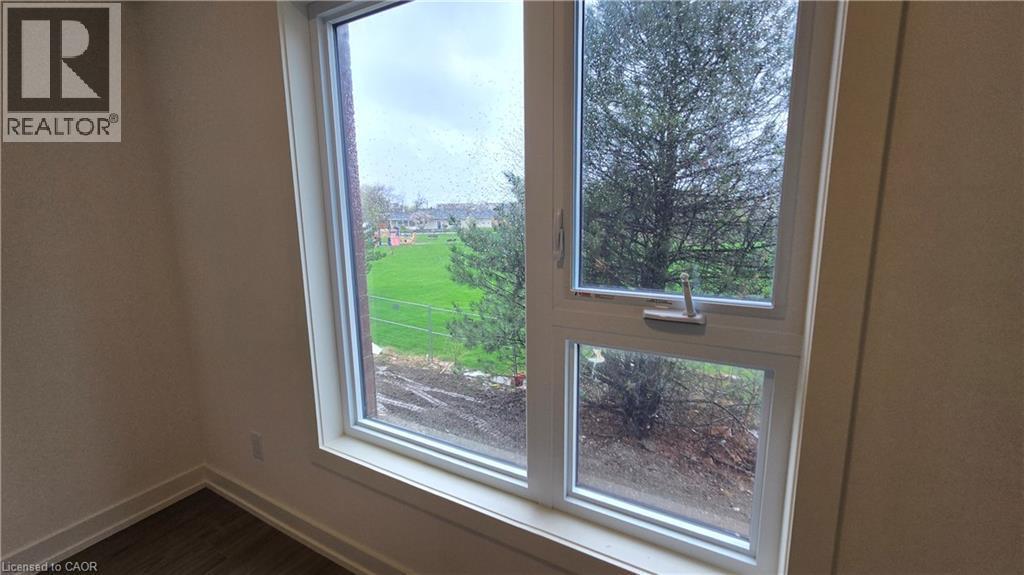 Double-pane window featuring white trim and a casement-style opening - 16 Melbourne Avenue Unit# 210B, St. Catharines, ON - Indoor Photo Showing Other Room