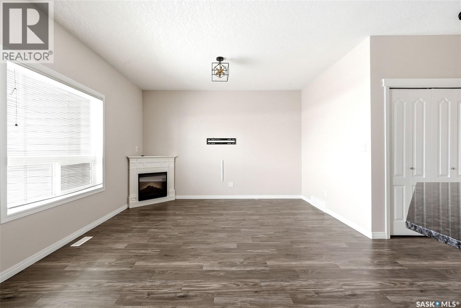 401 3826 Dewdney Avenue E, Regina, SK - Indoor Photo Showing Other Room With Fireplace