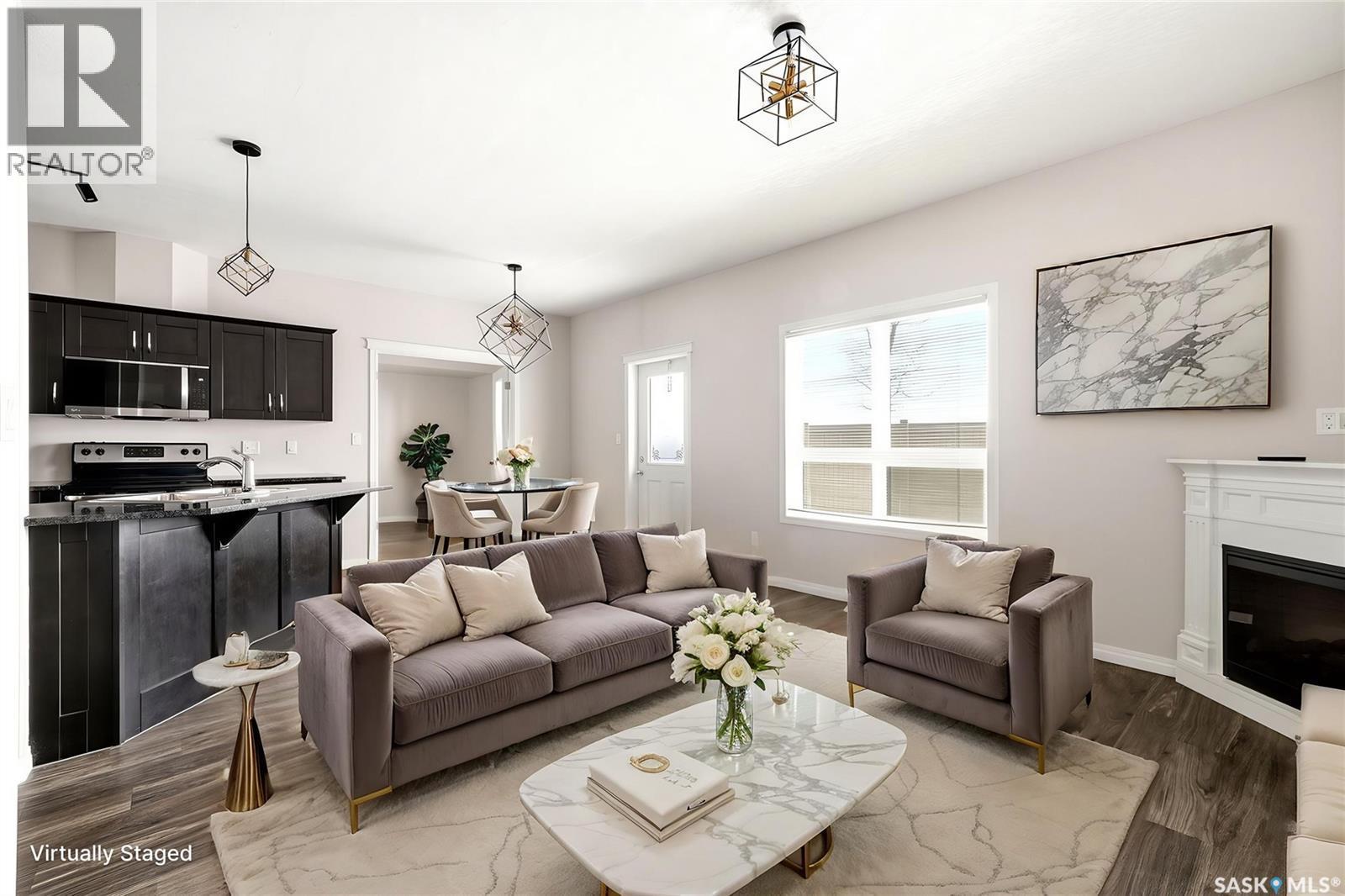401 3826 Dewdney Avenue E, Regina, SK - Indoor Photo Showing Living Room With Fireplace