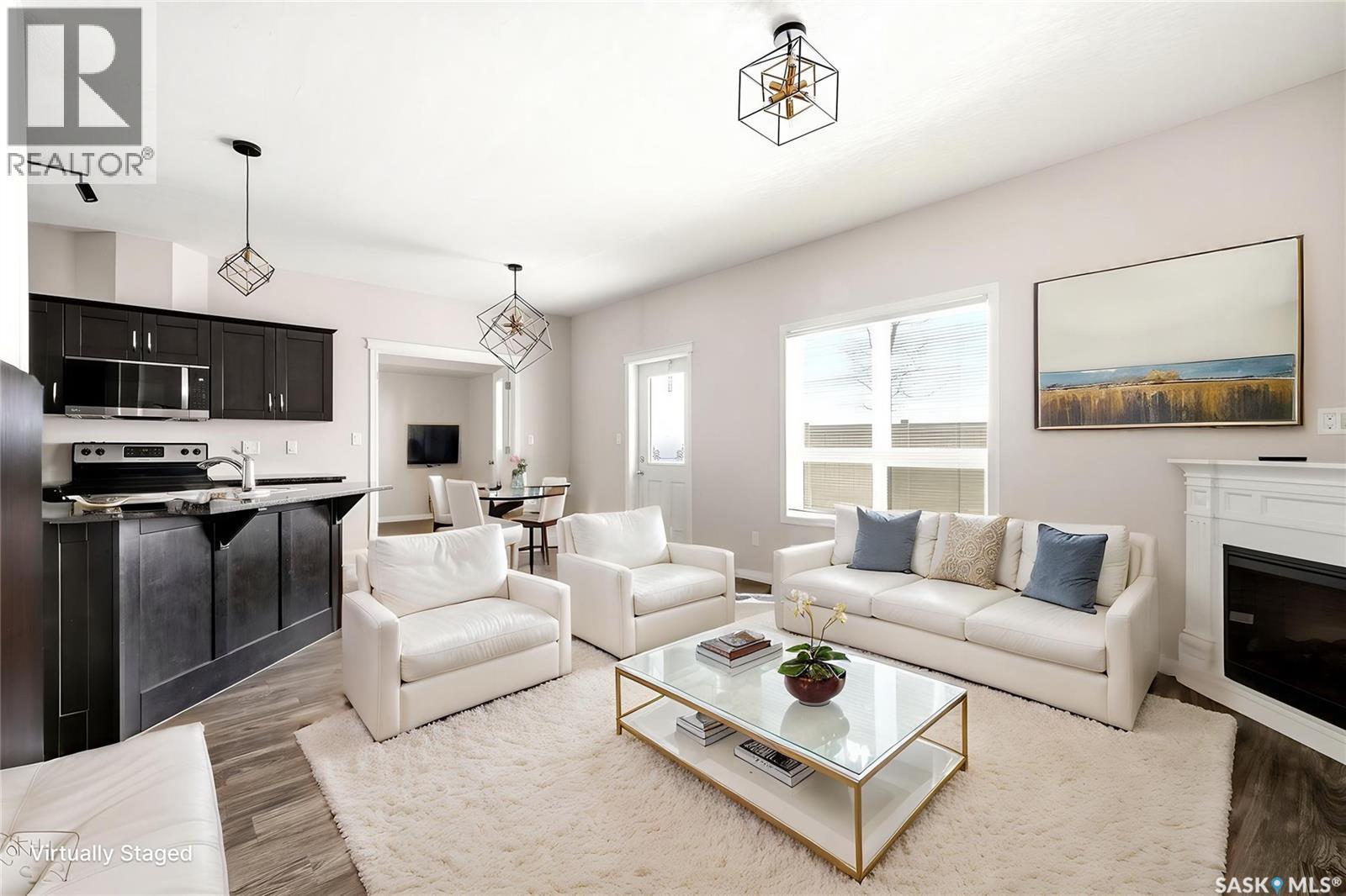 401 3826 Dewdney Avenue E, Regina, SK - Indoor Photo Showing Living Room With Fireplace