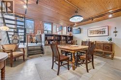 Dining space featuring wood ceiling, track lighting, and concrete flooring -