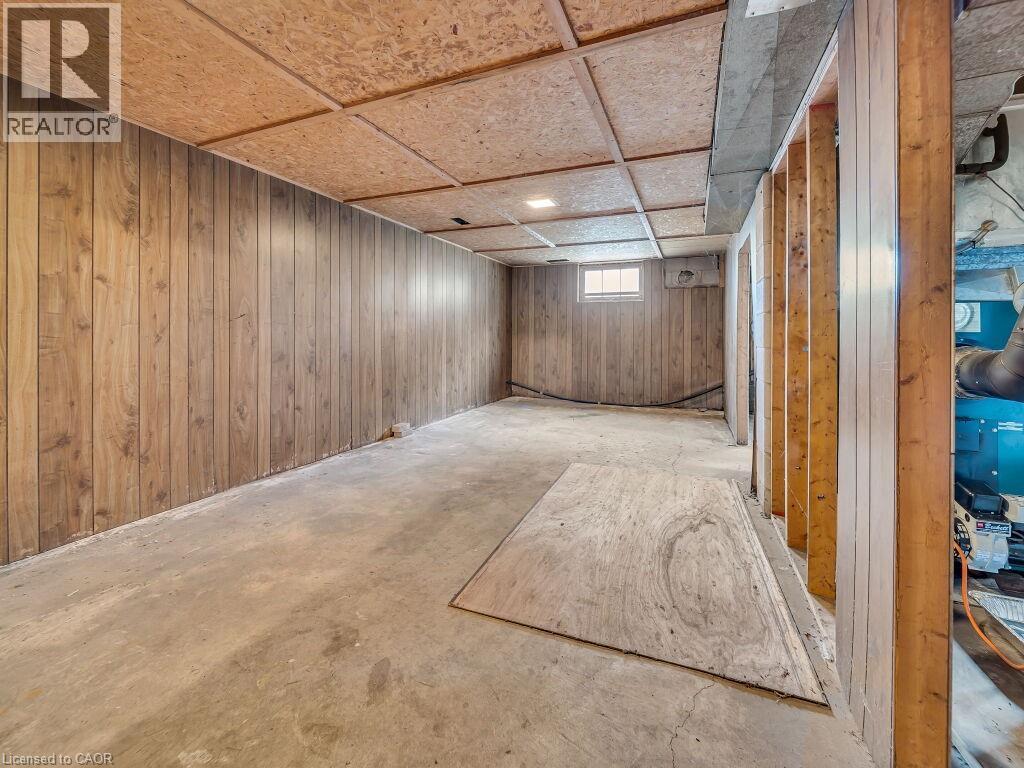 Lower-level interior featuring wood-panel walls and an exposed wood-frame structure - 1416 Highway 6, Hamilton, ON - Indoor Photo Showing Other Room
