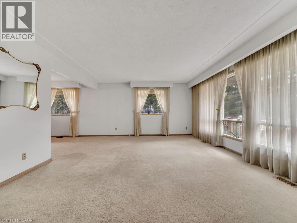 Expansive interior space featuring light-toned carpeting and white walls - 1416 Highway 6, Hamilton, ON - Indoor Photo Showing Other Room