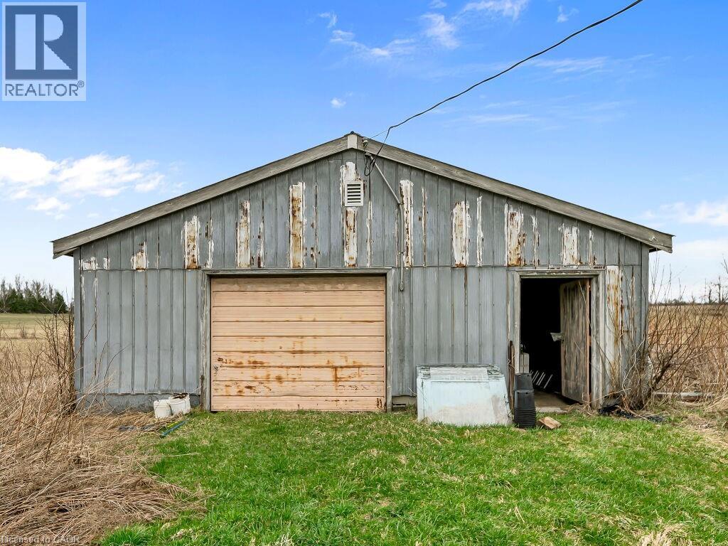 Utility building featuring a single garage door and an additional entry point - 1416 Highway 6, Hamilton, ON - Outdoor With Exterior