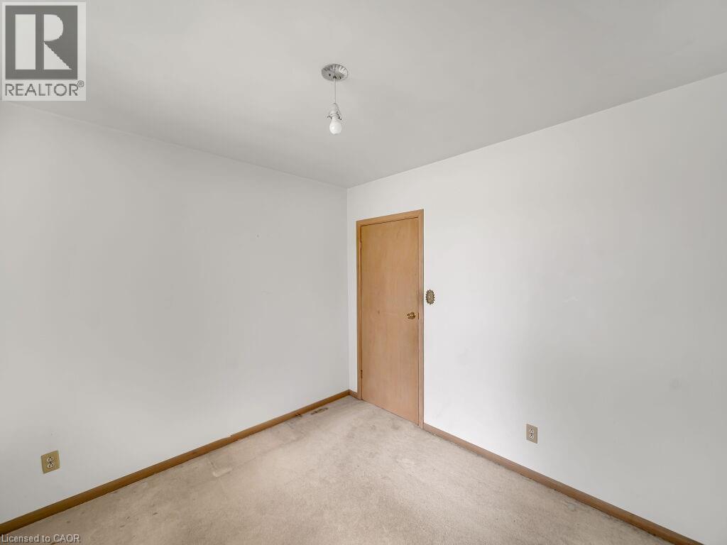 Interior room featuring light-toned walls, a neutral carpeted floor, and a flush-mount ceiling light fixture - 1416 Highway 6, Hamilton, ON - Indoor Photo Showing Other Room