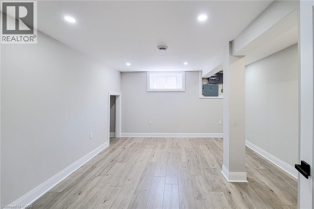 Spacious interior featuring light wood-finish flooring, recessed lighting, and a white trim package - 103 East 45Th Street, Hamilton, ON - Indoor