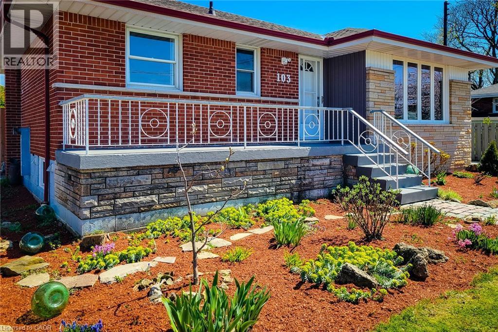 Brick and stone-clad exterior with a white railing porch and front steps - 103 East 45Th Street, Hamilton, ON - Outdoor