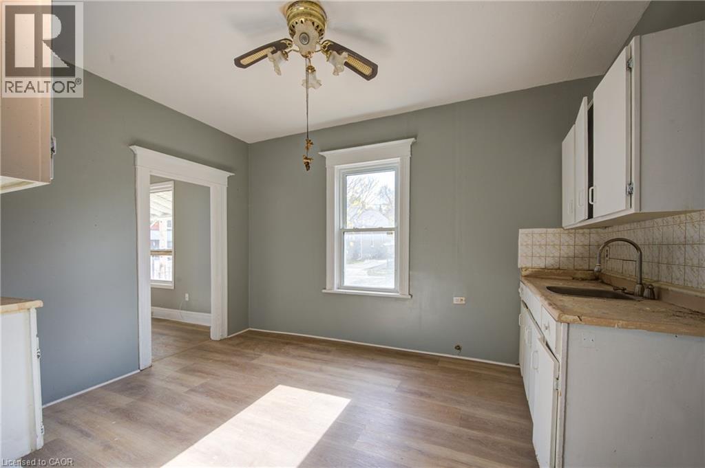 Kitchen area featuring wood-finish flooring, light gray wall paint, and white trim work - 1 Rathgar Street, London, ON - Indoor Photo Showing Kitchen