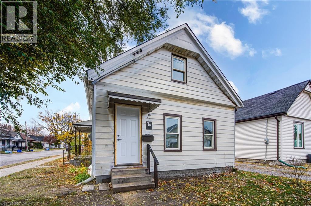 Unit 1A Entrance; White siding exterior with a dark shingle roof and contrasting trim - 1 Rathgar Street, London, ON - Outdoor