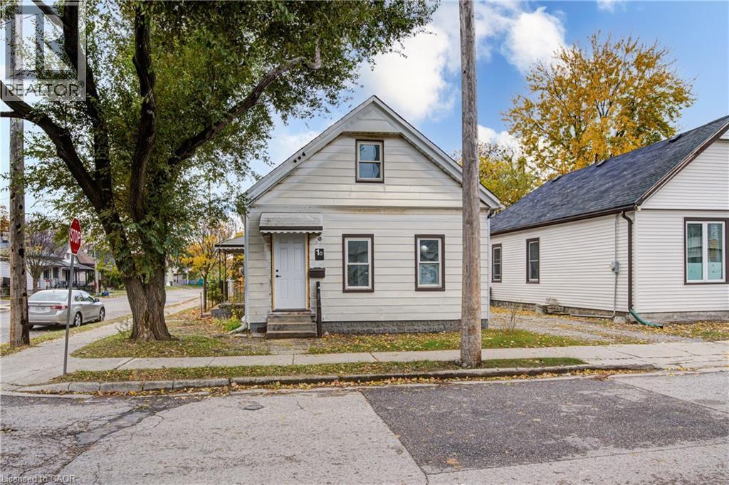 White siding residence featuring a pitched roof, front entry with awning, and multiple windows with dark trim - 1 Rathgar Street, London, ON - Outdoor