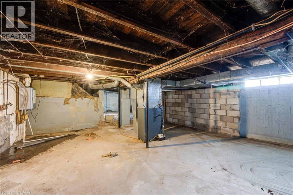 Lower level featuring concrete flooring, exposed wood ceiling joists, and a partial block wall - 1 Rathgar Street, London, ON - Indoor Photo Showing Basement