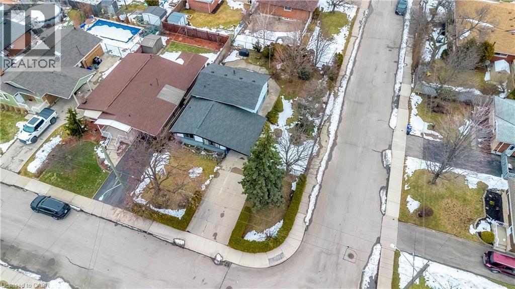 Property featuring a paved driveway, mature trees, and a landscaped front yard - 85 Ranchdale Drive, Hamilton, ON - Outdoor With View
