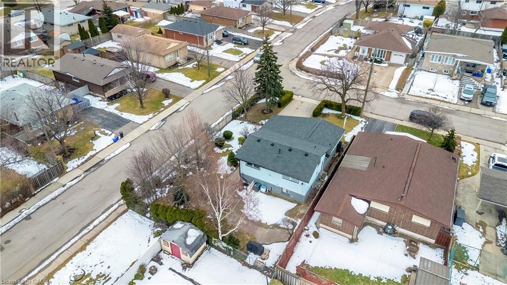 Aerial perspective showcasing a residential neighborhood with detached homes, paved streets, and established trees - 85 Ranchdale Drive, Hamilton, ON - Outdoor With View