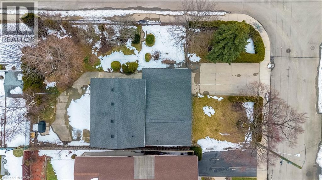 Property featuring a gray shingle roof, concrete driveways, and established landscaping - 85 Ranchdale Drive, Hamilton, ON - Outdoor With View