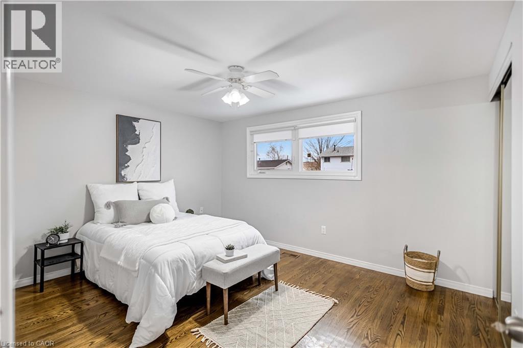 Hardwood-finish flooring enhancing the bright bedroom space - 85 Ranchdale Drive, Hamilton, ON