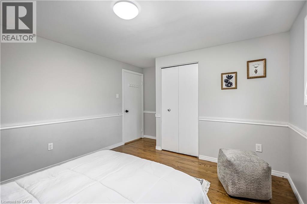 Hardwood flooring complemented by chair rail molding and neutral wall tones - 85 Ranchdale Drive, Hamilton, ON