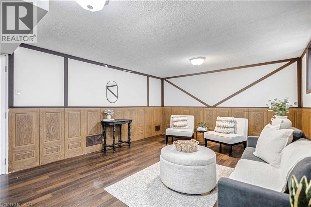 Finished lower level space featuring wood-finish flooring - 85 Ranchdale Drive, Hamilton, ON