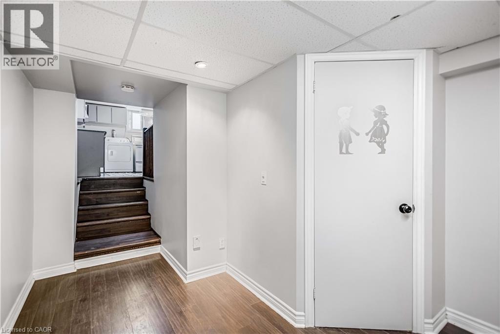 Finished lower-level space featuring wood-finish flooring, recessed lighting, and white trim - 85 Ranchdale Drive, Hamilton, ON
