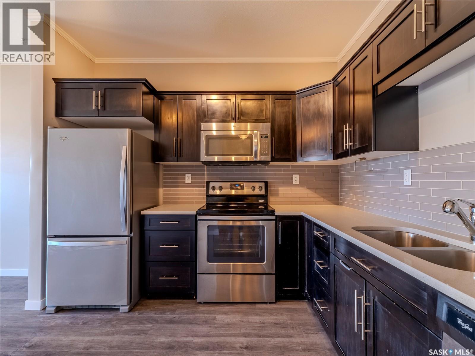 102 720 Baltzan Boulevard, Saskatoon, SK - Indoor Photo Showing Kitchen With Double Sink