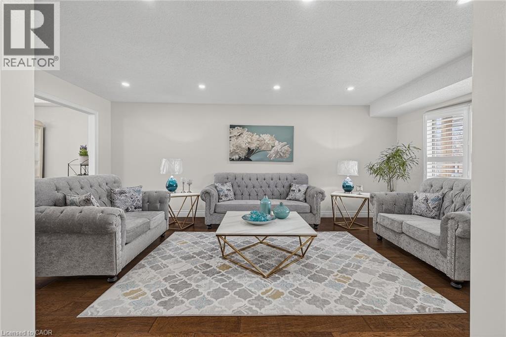 Spacious interior featuring wood-finish flooring, recessed lighting, and white walls - 79 Holbrook Crescent, Cambridge, ON - Indoor Photo Showing Living Room