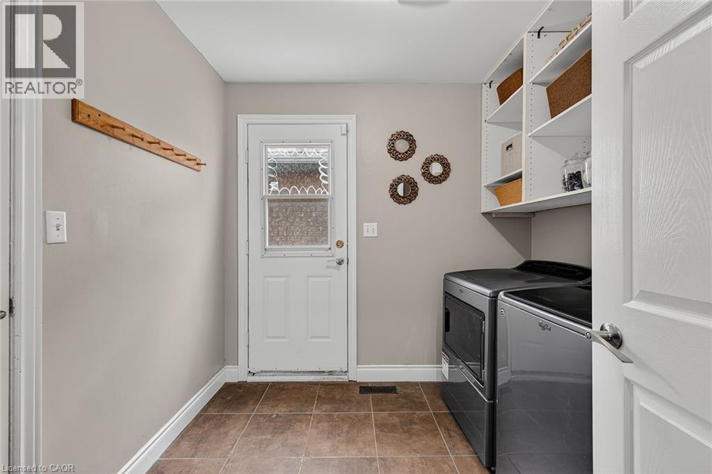 Dedicated laundry area featuring modern appliances, organized shelving, and tile flooring - 79 Holbrook Crescent, Cambridge, ON - Indoor Photo Showing Laundry Room