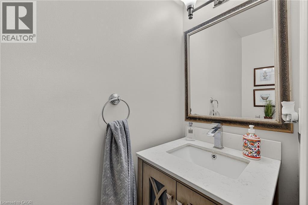 Bathroom vanity with a rectangular undermount sink, a chrome single-handle faucet, and a light-toned countertop - 79 Holbrook Crescent, Cambridge, ON - Indoor