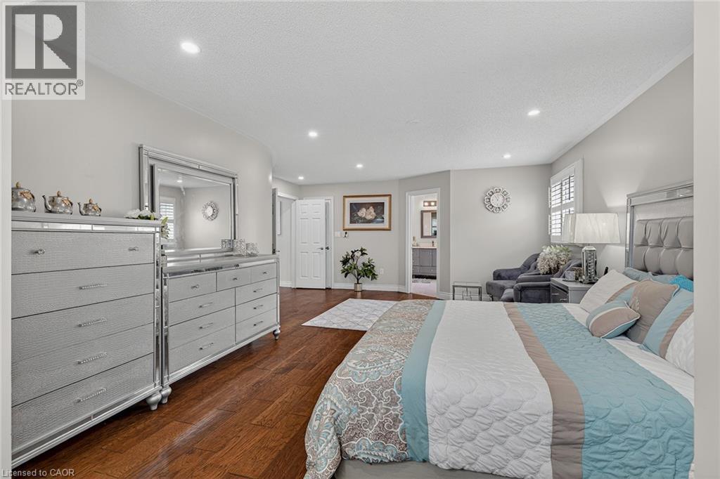 Hardwood flooring complements light gray walls throughout this spacious bedroom - 79 Holbrook Crescent, Cambridge, ON - Indoor Photo Showing Bedroom