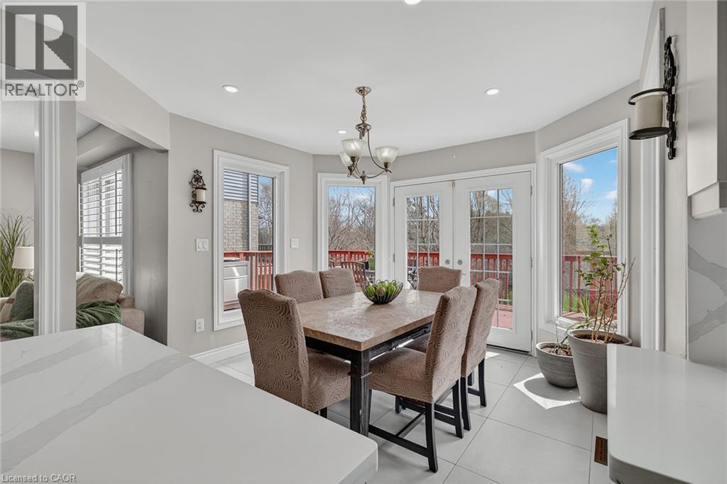 Dining area with double glass panel doors opening to an exterior deck - 79 Holbrook Crescent, Cambridge, ON - Indoor Photo Showing Dining Room