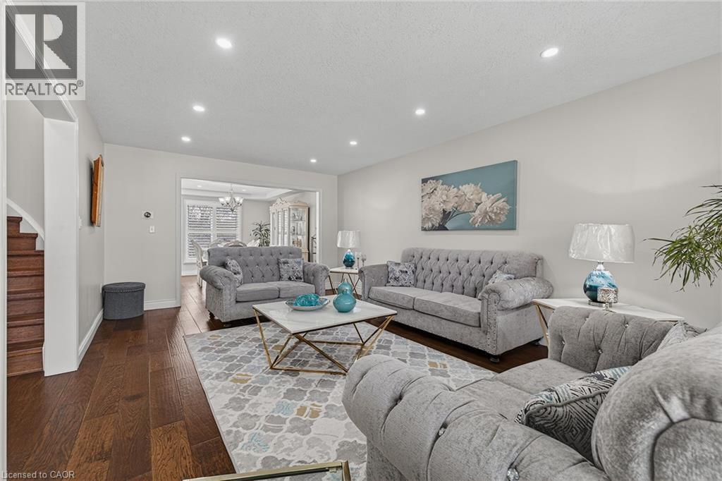 Recessed lighting illuminates the living area featuring wood-finish flooring and light-toned walls - 79 Holbrook Crescent, Cambridge, ON - Indoor Photo Showing Living Room