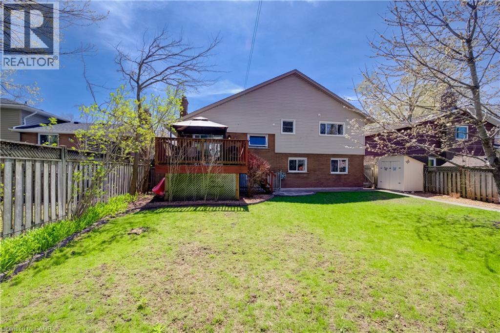 Expansive backyard featuring a manicured lawn, a two-story deck with a gazebo, and a storage shed - 172 Rennie Drive, Kitchener, ON - Outdoor