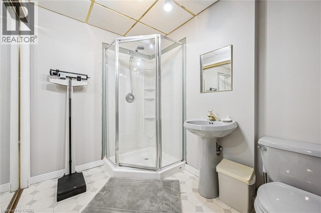 Room featuring wood-finish flooring, a ceiling fan with integrated lighting, and a single window with white trim - 42 Trailview Drive, Kitchener, ON - Indoor Photo Showing Office