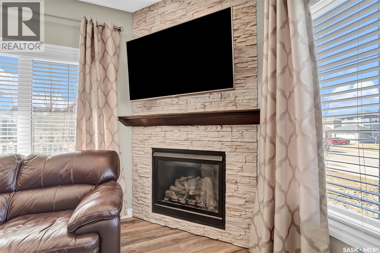 102 Atton Crescent, Saskatoon, SK - Indoor Photo Showing Living Room With Fireplace