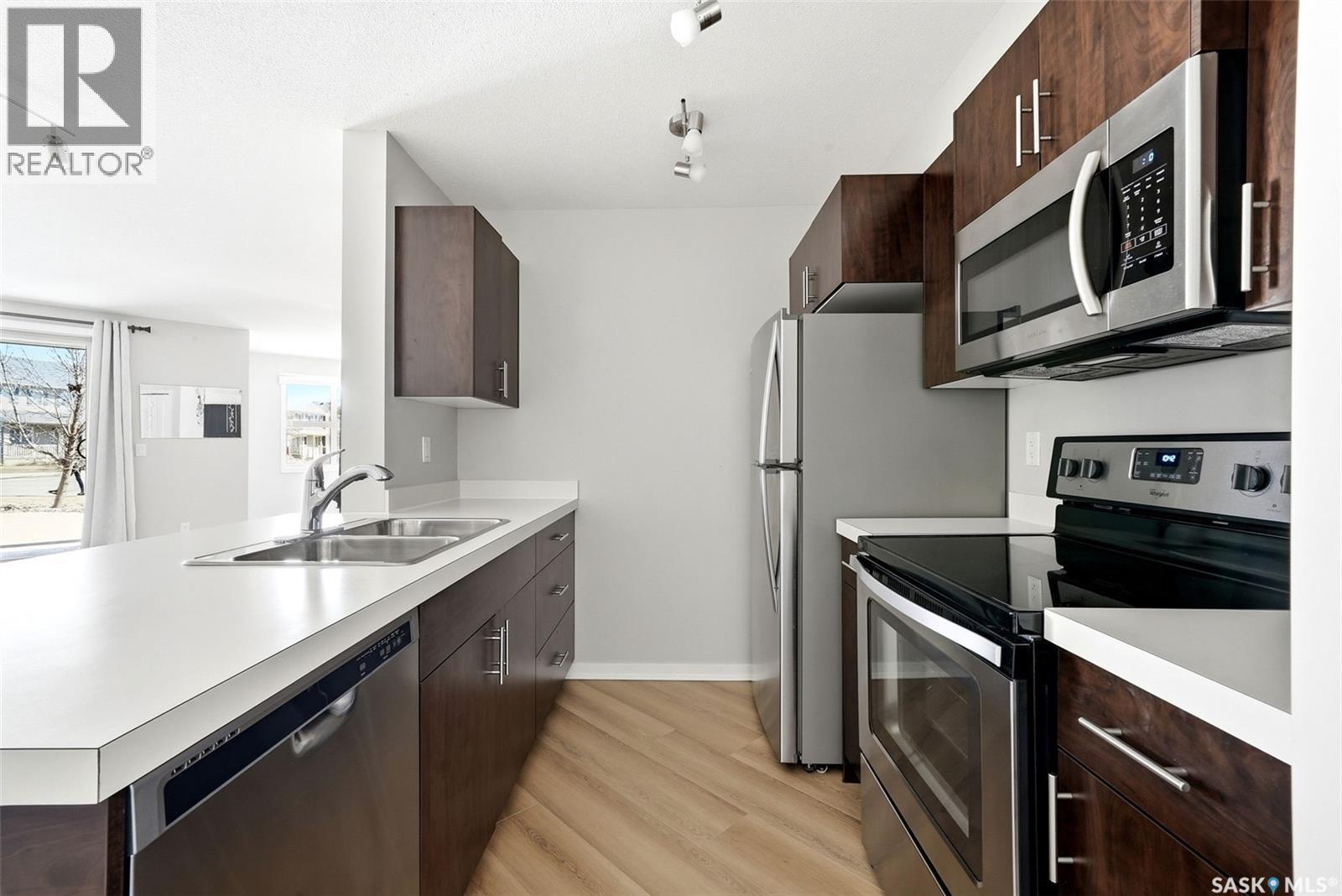 1115 5500 Mitchinson Way, Regina, SK - Indoor Photo Showing Kitchen With Stainless Steel Kitchen With Double Sink