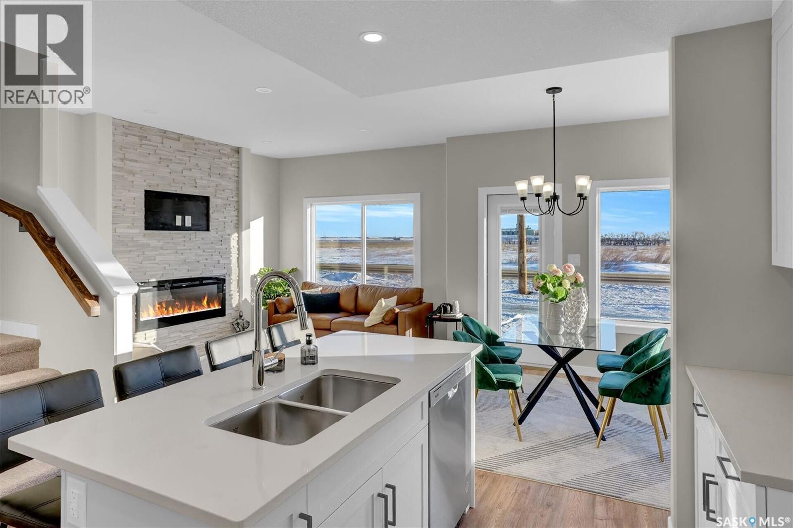 414 Leskiw Bend, Saskatoon, SK - Indoor Photo Showing Kitchen With Fireplace With Double Sink